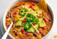 Bowl of Crockpot Vegetarian Tortilla Soup with lentils, beans, corn, and peppers – a Soup Hearty and comforting meal, perfect as the Best Vegetarian Soup and one of the top Veggie Slow Cooker Recipes for cozy nights.