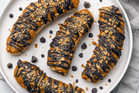Frozen Banana Snickers made with peanut butter, dark chocolate, and peanuts – a no-bake treat perfect for Organic Eating Recipes, Healthy Fats Snacks, Lunchbox Sweet Treats, Sugar Free Low Calorie Snacks, Healthy On The Go, Sugar Free Frozen Desserts, Low Calorie Meals And Snacks, and Healthy Snacks On The Go For Adults – the ultimate Healthy Candy Bar idea.