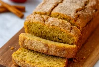Close-up Of Apple Cinnamon Bread loaf coated in cinnamon sugar, inspired by Apple Cider Donuts — a cozy Apple Cider Donut Bread Recipe that tastes like Farmhouse Apple Fritter Bread With Cider Glaze. Perfect Dessert Bread for fall, great for fans of Bread Recipes Sweet and Bread Recipes Homemade who want to learn How To Make Apple Cider Bread or How To Make Apple Cider Donut Bread at home.