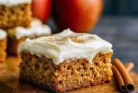 Close-up of gooey Maple Apple Desserts blondies with Cream Cheese Blondies Recipe frosting, perfect Fall Theme Recipes treat, a Call Dessert for Fall Blondies Recipe lovers, part of Best Fall Deserts and Unique Fall Dessert Recipes, ideal Fall Recipes With Apples and Fall Bake Recipes.