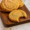 Overhead shot of a plate piled high with Chewy Pumpkin Snickerdoodle Cookies, rolled in cinnamon sugar and slightly cracked on top. Perfect for cozy baking, these Pumpkin Butter Cookies are a must for anyone looking for Fall Inspired Cookie Recipes or chewy, spiced Pumpkin Cookie ideas.