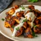 A plate of juicy Chicken Shawarma With Creamy Garlic sliced into strips, topped with a drizzle of creamy garlic sauce, and served with pita, fresh herbs, cucumbers, and tomatoes — a flavorful Protein Based Dinner and one of the best Grilled Chicken Shawarma Recipe ideas for easy weeknight meals.