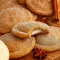 A batch of chewy Apple Cider Cheesecake Cookies filled with creamy cheesecake, brushed with butter, and dusted in spiced sugar — the ultimate Fall Festive Food and one of the Best Fall Cookie Recipes for cozy baking.