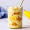 Close-up of a jar showing stacked protein banana pudding, crushed wafers, and banana slices — a tasty idea for Things To Add Protein Powder To and a clean Vanilla Protein Dessert Recipes option; great as Soft Foods With Protein and tested with Ascent Protein Recipes.