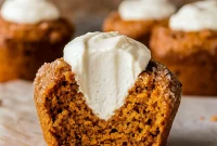 Close-up of moist Pumpkin Muffins With Maple Cream Cheese, topped with cinnamon sugar and filled with creamy maple cream cheese—perfect Thanksgiving Dishes Dessert idea. These bakery-style Pumpkin Cream Cheese Desserts look like Pumpkin Cream Cheese Crumble Muffins with a touch of sparkle, giving the cozy feel of Pumpkin Spice Muffins With Whipped Cream. Beautifully golden Pumpkin Muffins Filled With Cream Cheese and optional Nut-topped Pumpkin Muffins, ideal for seasonal Fall Baking Recipes and festive Pumpkin Recipes Dessert creations.