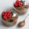 Glass jar of silky chocolate pudding topped with berries and cacao nibs, made from Blended Chia Seeds.