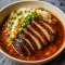 Bowl of tender Soy Chicken served over fluffy rice in a garlic ginger broth, topped with fresh herbs – the perfect cozy comfort meal for lovers of Asian Dishes and quick Chicken Dinner Recipes.