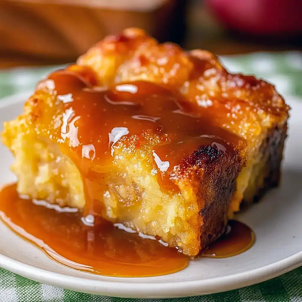 Close-up of whiskey caramel bread pudding with glossy caramel drizzle, golden-brown custardy top, and a side of fresh berries — plated with a scoop of vanilla ice cream.