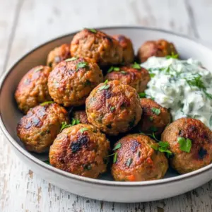 Lentil Dinner Recipes — golden-brown baked Greek lentil meatballs on a platter with tzatziki and fresh herbs, showing a hearty Green Lentil main; a visual nod to Recipes Using Lentils, versatile Meals With Lentils, everyday Lentil Meals, go-to Recipes With Lentils, classic Lentils Recipe, easy Lentil Dinner, and vibrant Green Lentil Recipes.