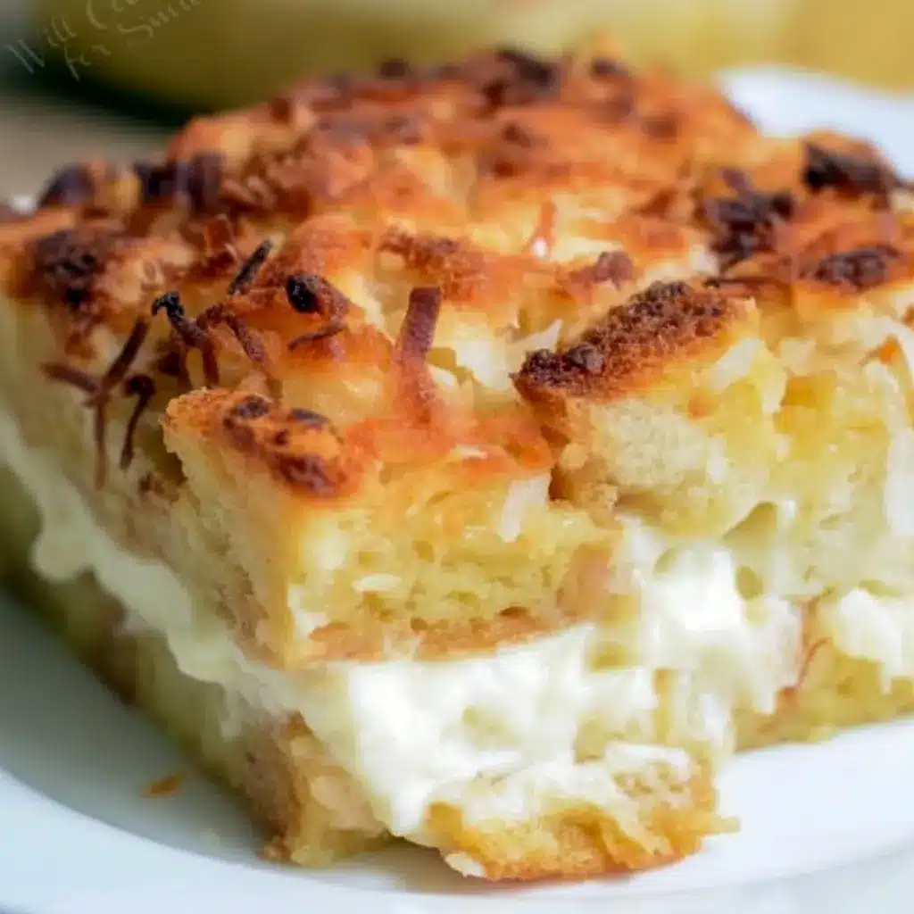 Warm slice of coconut cheesecake bread pudding topped with toasted coconut.