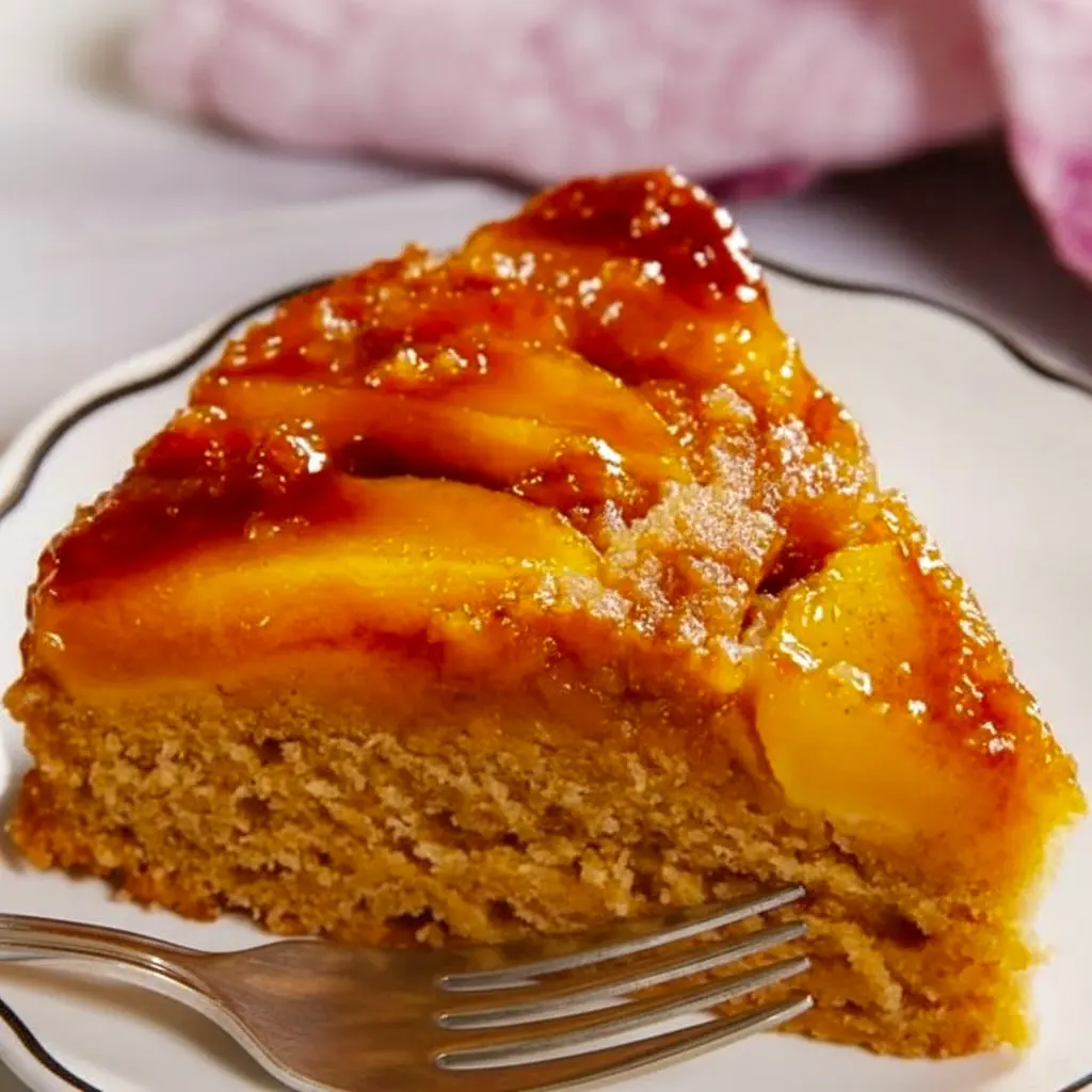 A moist and golden upside-down Caramel Apple Cake topped with glossy caramelized apples, styled like a cozy fall dessert inspired by a classic pineapple version, Pineapple Upside-down Cake With Apples.