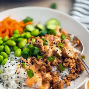 A colorful Bang Bang Ground Turkey Bowl topped with creamy sauce, sesame seeds, and green onions — an easy Low Effort Dinner inspired by Define Dish Recipes, perfect for Non Red Meat Meals and weeknight Alpha Gal Meals.