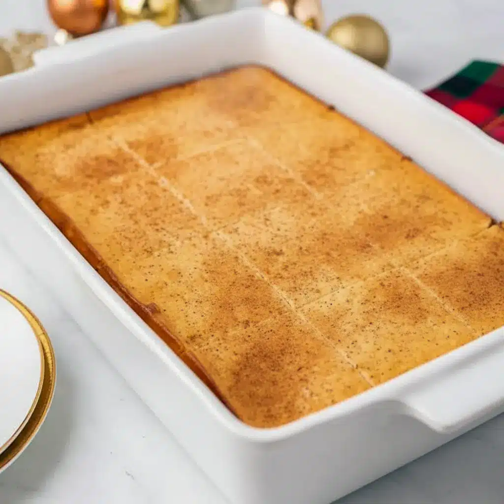 Close-up of chilled Eggnog Brownies topped with a dusting of nutmeg and a swirl of whipped cream.