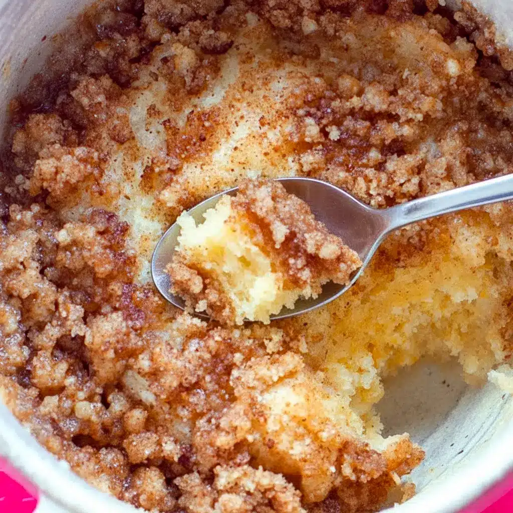 Single-serve mug cake with golden streusel topping, served warm in a white mug, Coffee Mug Cake.