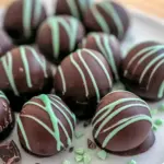 Truffle Recipe close-up: glossy mint chocolate spheres on a platter, ideal for Christmas Candy Recipes and Candy Recipes Homemade gift boxes, Christmas Truffles.