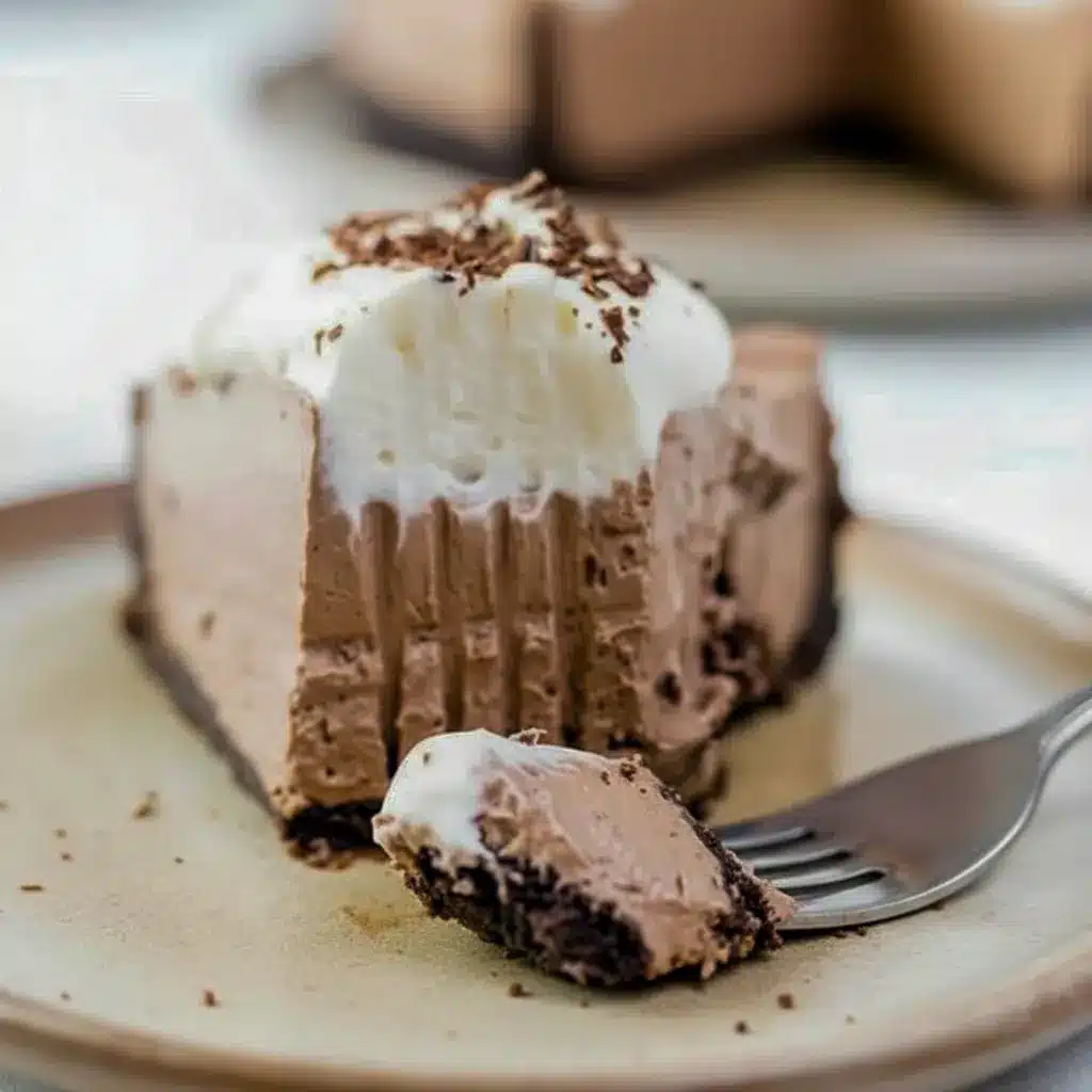 Dessert Parfait-style shot of a glossy chocolate pie slice topped with whipped cream and shavings, a tempting example of Keto Friendly Desserts and Low Carb Sweets, Low Carb Dessert.