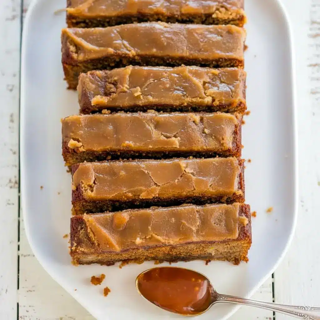 Sliced caramel macchiato banana bread on a wooden board, glossy brown-sugar glaze dripping, with a halved banana and a small jar of caramel beside it, Best Caramel Banana Bread.