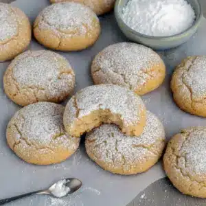 Spiced Christmas Cookies piled on a rustic board, dusted with nutmeg-sugar and ready for gifting.