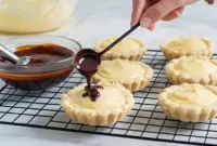Tray of Boston Cream Pie Cookies: golden cookie cups filled with creamy custard and topped with shiny chocolate ganache — a dreamy example of The Best Cookie Recipes Ever with decadent Cookie Fillings.