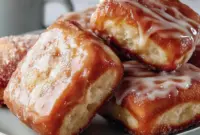 Close-up of glossy maple-glazed Donut Bar squares on a wooden Serving Platters board, sprinkled with powdered sugar — ideal Dessert Squares for breakfast or brunch.