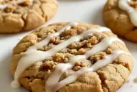 Coffee Cake Cookies on a wire rack: golden, streusel-topped cookies with a glossy icing drizzle, styled beside a steaming mug of coffee.