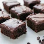 Close-up of chilled, fudge-like chocolate brownies cut into squares on parchment paper, Sweets That Are Healthy.