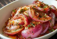 Jar of glossy Hot Honey Pickled red onion rings, bright pink and ready to top tacos or salads — a handy Quick Pickled Onions condiment.