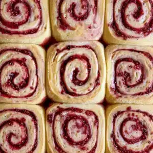 Freshly baked Sourdough Raspberry Lemon Rolls Recipe arranged in a baking dish, showcasing golden swirls of Raspberry Sourdough filled with jammy fruit, inspired by classic Sourdough Raspberry Roll Recipe techniques and vibrant Lemon Raspberry Sourdough flavors, perfect for fans of homemade Sourdough Raspberry Rolls and creative Sourdough Raspberry Recipes.