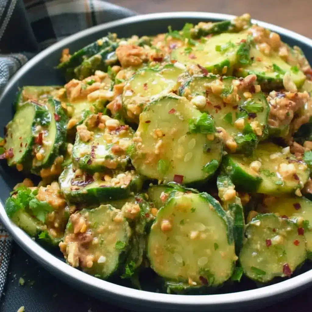 Bowl of Peanut Sauce Cucumber Salad: sliced cucumbers coated in spicy peanut dressing, topped with toasted peanuts and parsley — a bright Peanut Butter Lunch or side dish.
