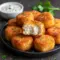 Close-up of golden Cottage Cheese Snack tots on a wooden board with a small bowl of creamy dip — a top Simple Snack Ideas pick.