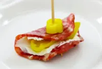 Platter of Salami Cream Cheese Pepperoncini Roll Ups arranged on a board, showing creamy centers and tangy pepperoncini — ideal Finger Food Appetizers for a crowd.