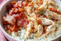 Chicken Bacon Ranch Cottage Cheese Bowl in a white bowl topped with shredded chicken, chopped bacon, and herbs — a cozy Macro-Friendly Dinner close-up.