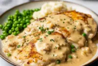 Golden-browned Boursin Cheese Chicken Bake topped with crispy panko and Parmesan, served on a plate with roasted asparagus.