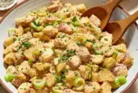 Bowl of creamy Cajun potato salad garnished with parsley and smoked paprika — a tasty Summer Southern Food side and top-rated Cajun Sides option for picnics and barbecues.