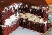 Sliced Ding Dong Cake showing moist chocolate layers and a fluffy cream filling — a classic Cakes With Filling look.