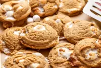 Close-up of a warm Peanut Butter Marshmallow Cookies cookie showing gooey marshmallow pockets and a tender, golden edge — a cozy Gluten Free Peanut Butter Dessert.