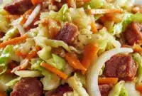 Skillet of Fried Cabbage with crispy bits of Bacon Fried Cabbage, golden onions, and garlic, styled in a rustic pan — a hearty Side Recipes idea.