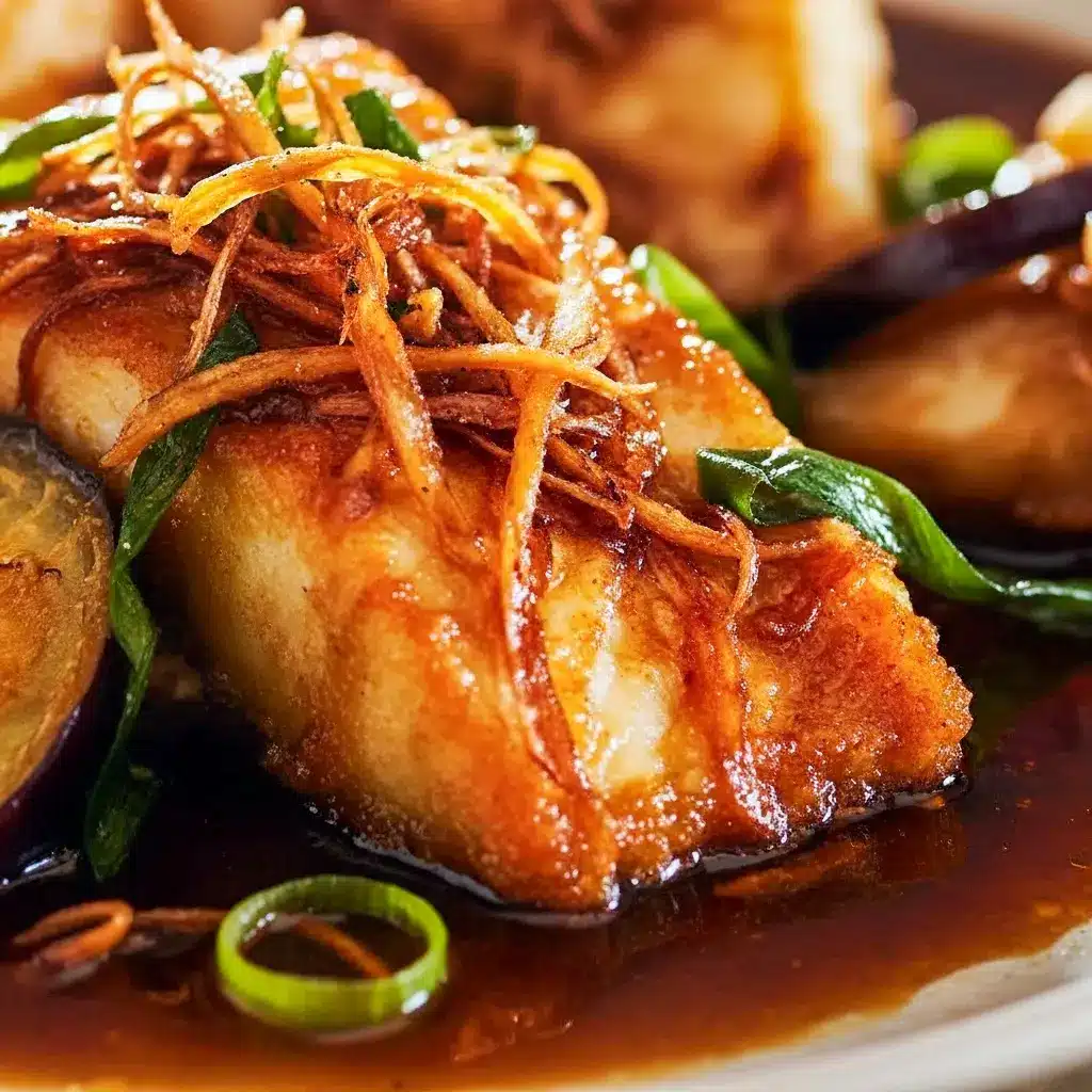 Close-up of golden pan-seared halibut glazed with soy-ginger sauce, topped with crispy ginger strips and scallions — an Asian Fish Dish Recipe and easy Asian Fish Dishes weeknight meal.