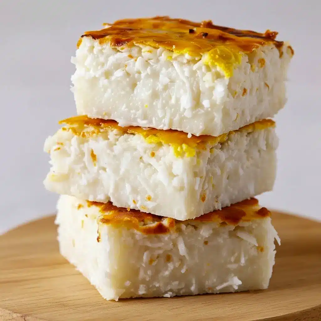 Close-up of a golden Sticky Coconut Cake square with sticky shredded coconut and a toasted crust — a classic Indonesian Dessert Recipes snack.
