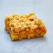 Mango Oatmeal Bars — golden oat crumble bars with bright mango filling stacked on a wire rack, ready to serve.