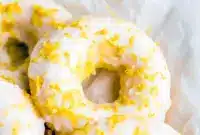 Stack of lemon-vanilla baked donuts with a glossy glaze — Easy Protein Donut Recipe styled as Glazed Protein Donuts and labeled Gluten Free Protein Donuts.