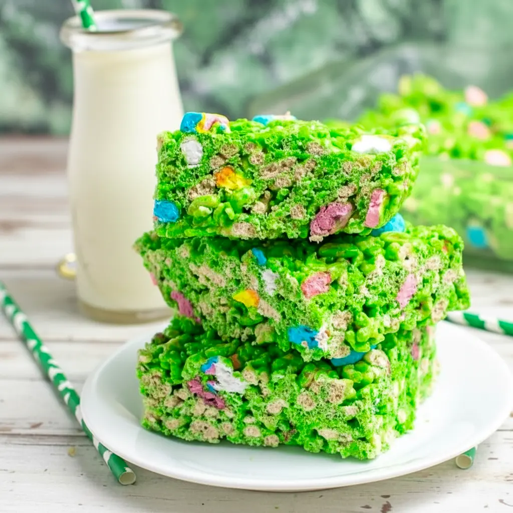 Close-up of a green Lucky Charms Rice Krispie square with marshmallow bits and a glossy finish — St Pats Day Snacks and St Patrick Day Treats styled on a festive platter, St. Patrick’s Day Treats.