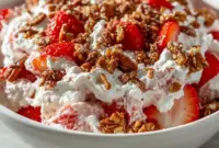 Strawberry Crackle Salad — creamy whipped filling layered with bright sliced strawberries and crunchy pretzel-pecan crackle in a bowl; a fresh, no-bake Light Cold Dessert ready for summer.