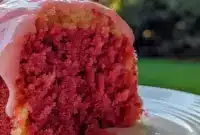 Close-up of a Honeybun-style sheet cake drizzled with Strawberry Icing, sprinkled with cinnamon sugar and fresh berries — a tempting Strawberry Cakes presentation.