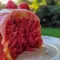 Close-up of a Honeybun-style sheet cake drizzled with Strawberry Icing, sprinkled with cinnamon sugar and fresh berries — a tempting Strawberry Cakes presentation.