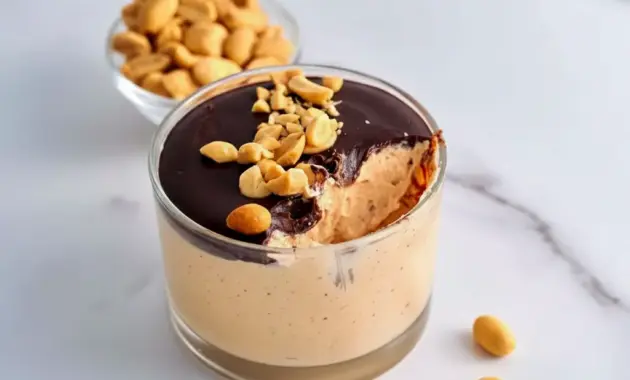 Jar of Cottage Cheese Peanut Butter Mousse drizzled with dark chocolate and chopped peanuts — a simple High Protein Desserts snack.