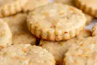 A plate of Carrot Cake Shortbread Cookies with a golden buttery texture, specks of carrot and walnut, and a light spring-inspired look for a cozy Carrot Cake Cookies pin.