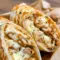 Close-up of Cheesy Garlic Chicken Wraps sliced open with melted cheese, garlic chicken filling, and golden crispy tortillas, styled as an easy Yummy Dinners idea.