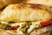 Chicken Pesto Sandwich on toasted ciabatta with juicy chicken, melted mozzarella, tomato slices, and pesto for a quick Healthy Chicken Sandwich Recipes style dinner.