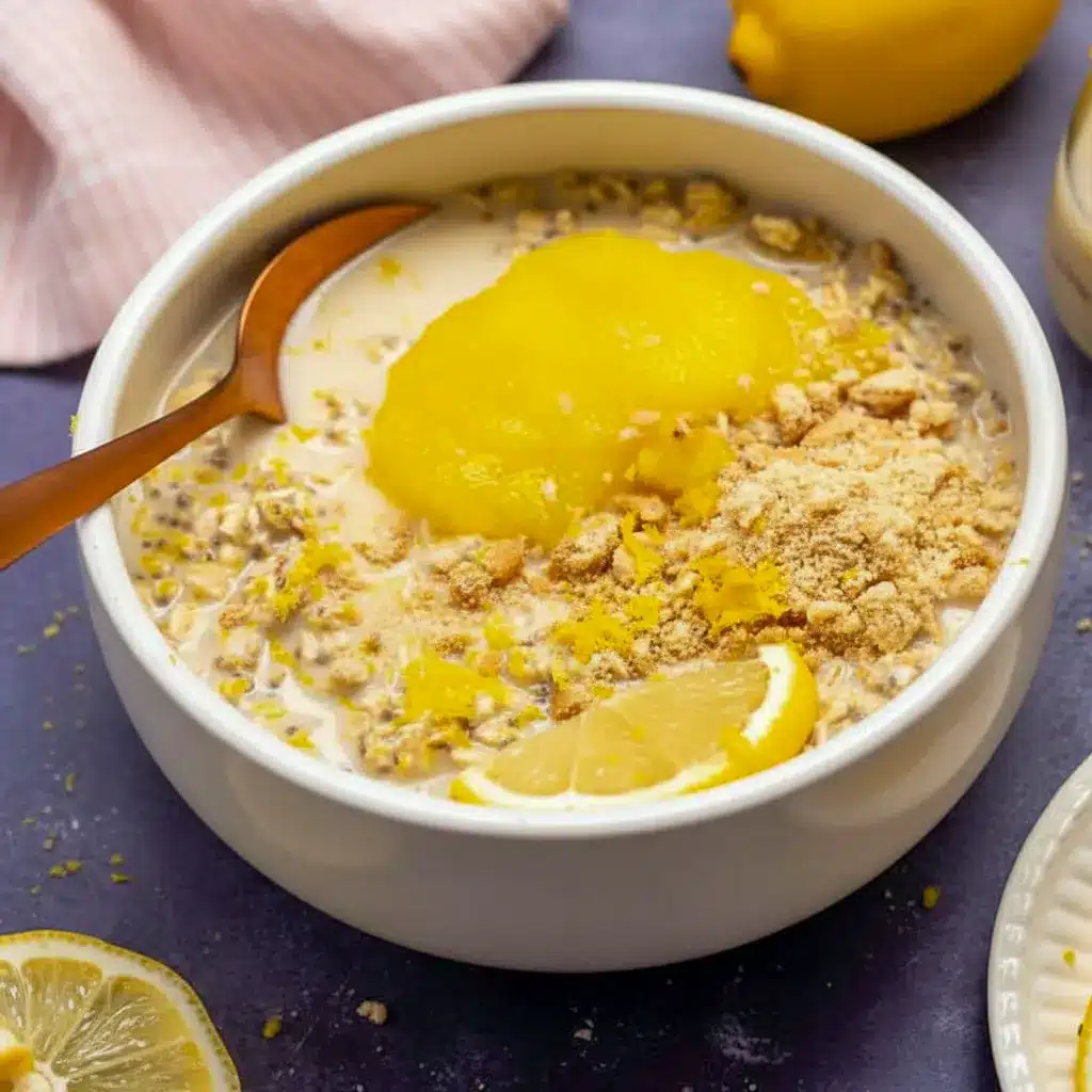 Lemon Cheesecake Overnight Oats in a jar, creamy and pale yellow, topped with lemon zest and fresh berries — a ready-to-eat Creamy Lemon Overnight Oats breakfast.